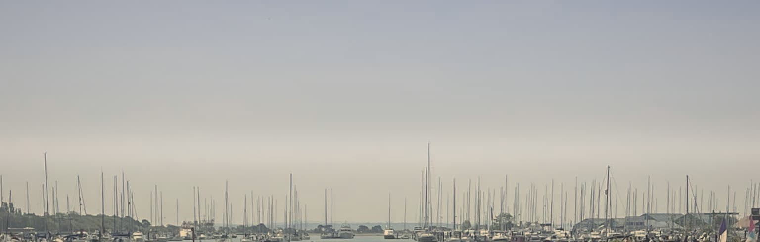 Moored boats on a still Hampshire estuary at first light